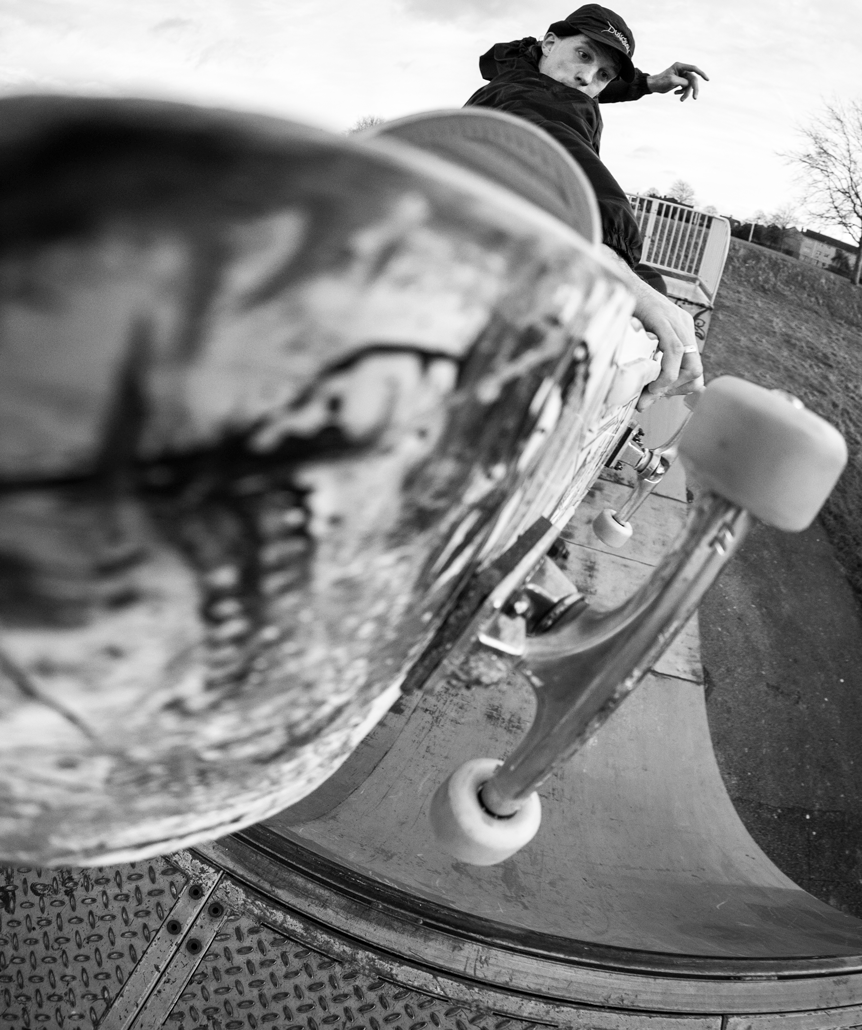 Black and white image skateboarder close up skateboard