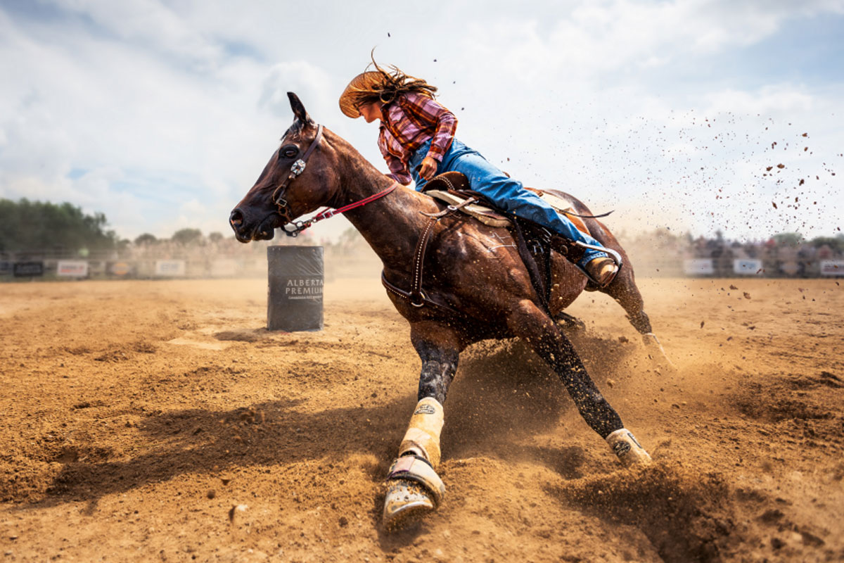 Slam on the Brakes, capturing a cowgirl in a barrel racing competition in Ontario, Canada. In these competitions, cowgirls ride around barrels with the quickest one crowned as the winner. © Zhenhuan Zhou, China Mainland, Winner, Open Competition, Motion, 2023 Sony World Photography Awards